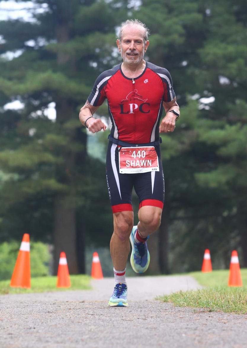 A close-up of a supportive handshake between two women in a gym setting, promoting wellness.