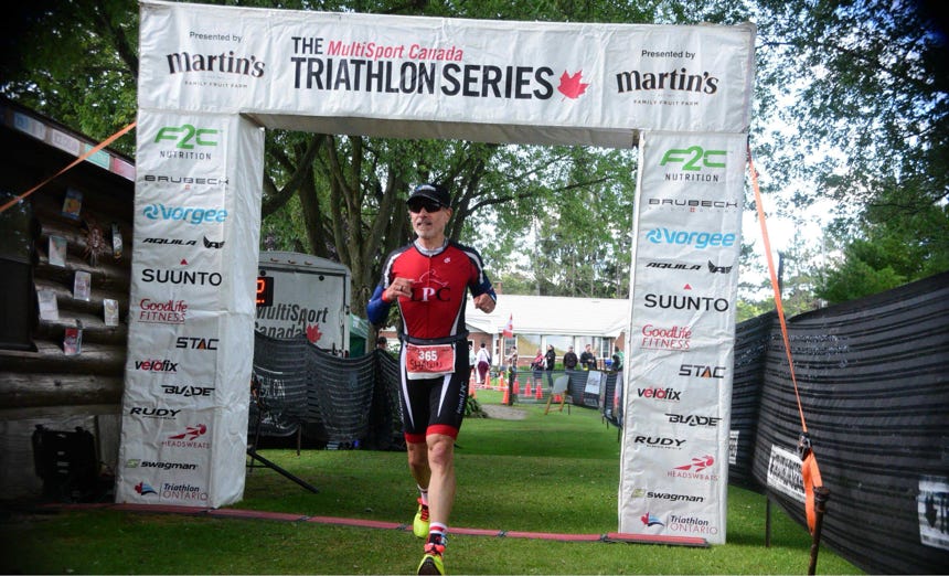 A group of diverse runners competing in an urban marathon on a sunny day.